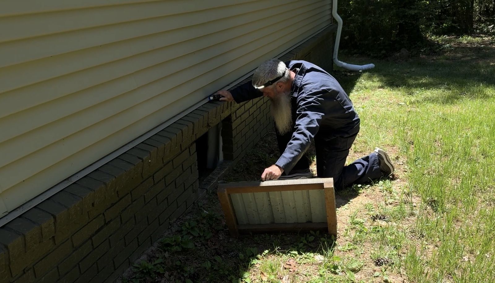 Jon Harris examining a home's accessible components during an inspection